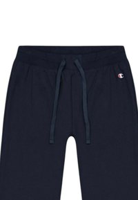 Navy blue jogger pants with an elastic waistband, drawstring, and small embroidered logo on the left. Soft cotton fabric with a smooth texture.