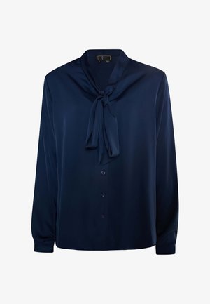 Tummansininen paita, joka on valmistettu sileästä kankaasta, kietoutuvalla kaulustyylillä, pitkillä hihoilla ja nappisuljenta edessä.