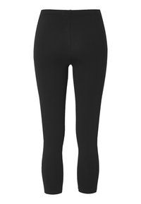 Svarta leggings tillverkade av stretchigt tyg, med hög midja och avsmalnande ankellängd utan ytterligare mönster eller detaljer.