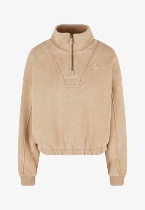 Beež pulloveri särk pool-aukudega kaela, soonikute käiste ja elastse äärisega. Omab sama tooni õmblusi ja väikest valget logo.