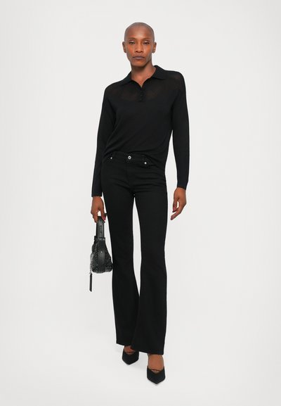 Black long-sleeve polo with a sheer striped pattern, paired with fitted black flared jeans. Accessories include a black beaded handbag and pointed heels.