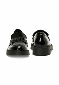 Black patent leather shoes with a smooth, shiny finish, rounded toe, and rubber sole. Features a decorative strap and buckle detail.