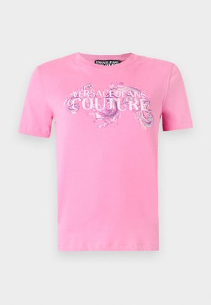 Ροζ κοντομάνικη μπλούζα με το κείμενο «Versace Jeans Couture» και διακοσμητικές σπείρες τυπωμένες στο στήθος.