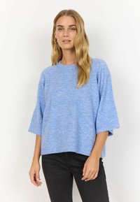 Helles blaues Sweatshirt aus weichem Material, mit Rundhalsausschnitt und kurzen, weiten Ärmeln. Das Design ist lässig geschnitten und wird mit schwarzen Hosen kombiniert.