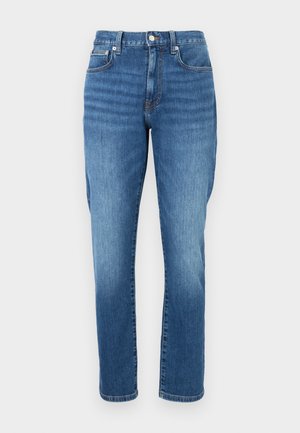 Jeans blu a vita alta con gamba dritta, cinque tasche, chiusura con bottoni e cuciture visibili.