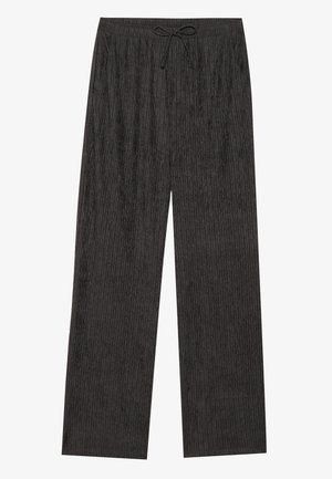 Pantalons larges texturés noirs avec une taille à cordon de serrage, présentant de subtiles rayures verticales et des poches latérales pour plus de fonctionnalité.
