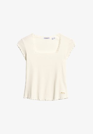 Biała, żebrowana bluzka z krótkim rękawem, z kwadratowym dekoltem, falbaniastym wykończeniem oraz małym, złotym logo na dole. Miękka tekstura i luźny krój.