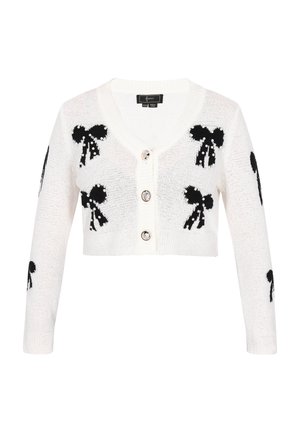 Hvid strikket cardigan med sorte sløjfemønstre. Har en dyb V-udskæring, tre knapper og cropped ærmer. Tekstileret stof med glimmer.