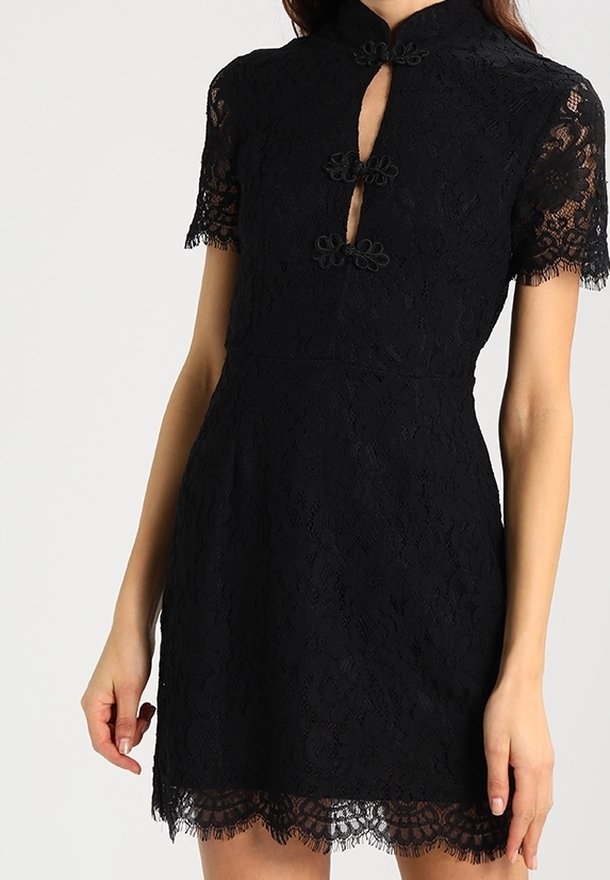 Black lace dress with short sleeves, a high collar, keyhole cutout, floral accents, and a scalloped hemline. Elegant textured fabric.