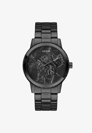 Montre noire avec un design de lion texturé sur le cadran, équipée de belles aiguilles des heures et des minutes en argent, et d'un bracelet en maillons métalliques.