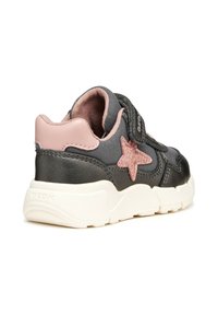 Baskets noires et roses avec une tige texturée, présentant un détail en étoile rose pailleté, une sangle Velcro et une semelle blanche épaisse.