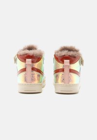 Baskets montantes en matériau synthétique irisé, avec des accents en vernis marron, des languettes rose clair et une doublure en fausse fourrure au niveau du col.