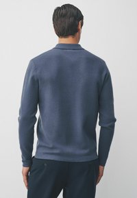 Navy blue knitted sweater with a straight cut, long sleeves, and a collar. Soft texture with smooth finish and subtle stitching detail.