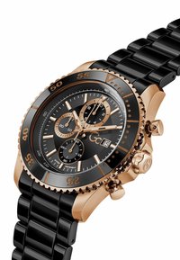 Fekete és rózsaarany színű kronográf karóra tachiméteres lünettával, három segédszámlappal, dátumkijelzővel és fekete fém láncszíjjal.
