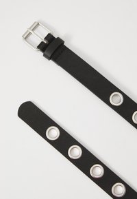 Ceinture en cuir noir avec une boucle en argent, texture lisse et trois œillets métalliques répartis uniformément le long de la longueur.