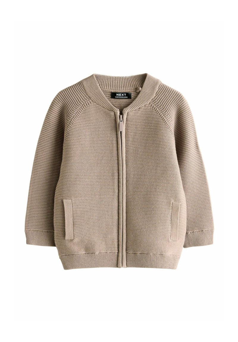 Maglione beige con zip, struttura a coste, collo rotondo e tasche laterali. Presenta un colore uniforme e materiale morbido in cotone.