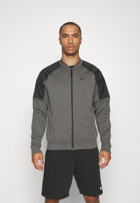 Nike Performance THERMA NOVELTY BOMBER - Chaqueta de entrenamiento - charcoal heather black/black