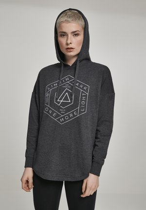 Dark gray hoodie made of soft fabric, featuring a hexagonal white graphic design with text and accents. Includes a front kangaroo pocket and drawstrings.
