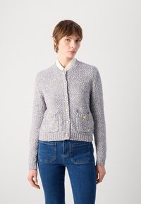Light blue knitted cardigan with a round neckline, button closure, two front pockets, and ribbed cuffs and hem.