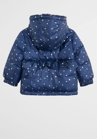 Marinblå vadderad jacka med huva, rynkad midja och silverstjärnmönster. Tillverkad av glänsande, slätt tyg med elastiska muddar och fåll.