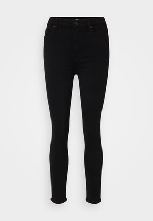 Black skinny jeans with a smooth, stretchy fabric, featuring a classic five-pocket design and subtle stitching details.