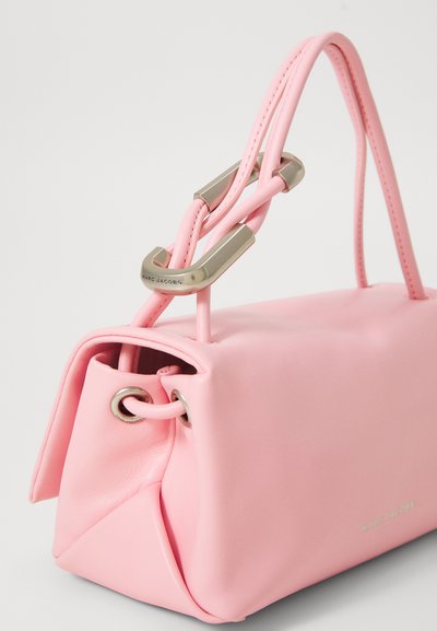 Soft pink leather handbag with double loop handle secured by silver metal clasp, embossed with "MARC JACOBS" logo on side and hardware.