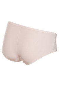 Beige katoenen blend slips met een gladde textuur, uitgerust met een laag uitgesneden ontwerp en een subtiel cirkelpatroon aan de zijkant.