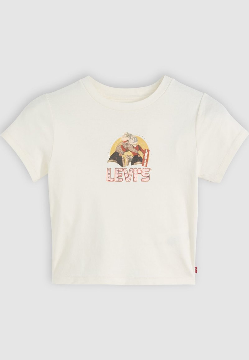 T-shirt crème à manches courtes arborant un imprimé graphique de deux personnages et le logo "Levi's" en rouge, avec un col rond et une coupe décontractée.