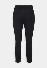 Black jogger pants with a soft fabric, elastic waistband, and two back pockets. Tapered leg design for a snug fit at the ankles.