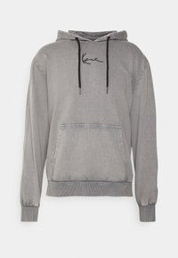 Grauer Kapuzenpullover mit einer Vordertasche, schwarzen Kordeln und bestickten Details. Verfügt über gerippte Bündchen und Saum. Weicher Stoff.