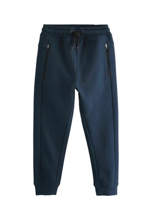 Pantalon de jogging bleu marine avec taille élastique, cordon noir, poches zippées et poignets côtelés.