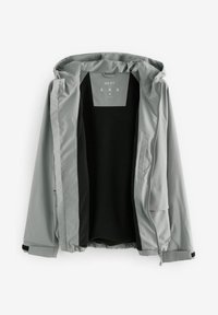 Veste à capuche gris clair avec doublure intérieure noire, dézippée, taille moyenne, montrant les poches avant et les détails de la fermeture éclair.