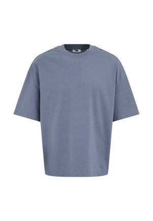 T-shirt oversize à manches courtes de couleur bleu uni avec col rond, présenté sur un fond blanc.