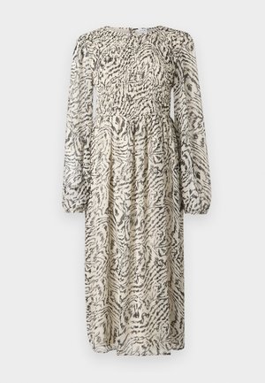 Robe à manches longues crème avec motif abstrait noir. Dotée d'un corsage smocké et d'une jupe fluide. Tissu léger, transparent avec une finition texturée.