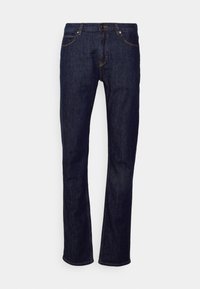 Mörkblå denimjeans med raka ben, kontrasterande orange sömnad, fem fickor och en klassisk dragkedja.