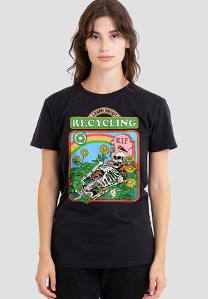 Young woman wearing black t-shirt with colorful recycling design featuring skeleton, flowers, bird, mushrooms, rainbow, and "R.I.P." gravestone.