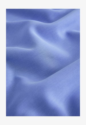 Light blue fabric with a smooth texture, showing subtle creases and folds. The material appears soft and lightweight.