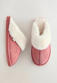 Pink suede slippers featuring a white faux fur collar, rounded shape, and a flat rubber sole, with visible stitching details on the upper.
