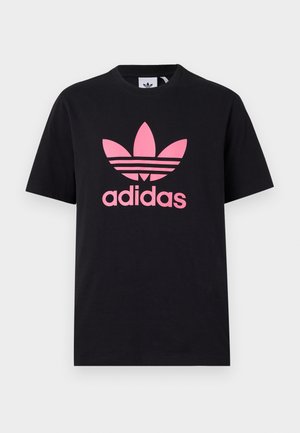 Black cotton T-shirt featuring a large pink Adidas logo with three stripes above it. Crew neckline and short sleeves. Classic fit.