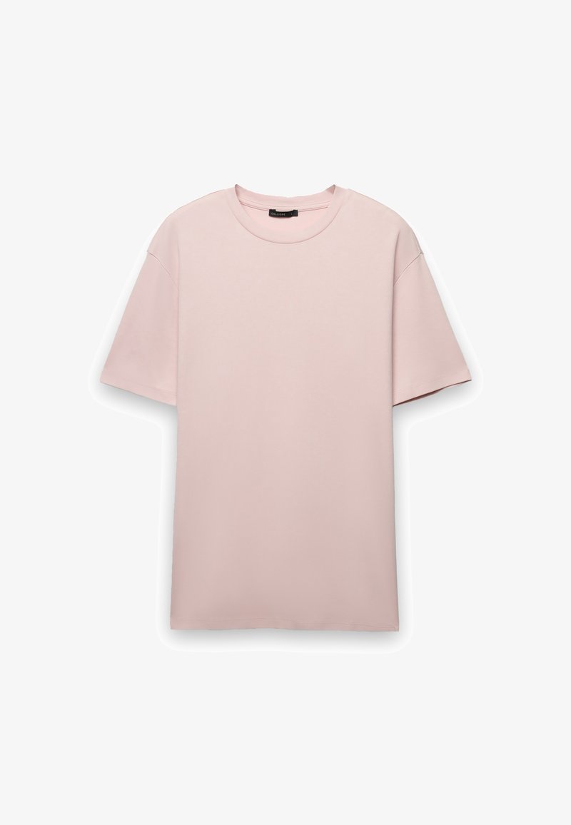 T-shirt rosa chiaro a maniche corte con scollo rotondo, realizzata in tessuto di cotone liscio, con vestibilità rilassata e senza chiusure visibili.