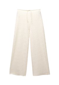 Pantalons larges de couleur crème en tissu texturé avec un motif en chevrons, dotés d'une taille élastique avec cordon de serrage pour un ajustement personnalisé.