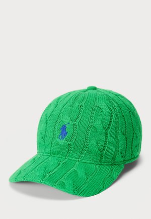 Green knit baseball cap with cable pattern, curved brim, and blue logo detail on the front. Textured fabric adds dimension.