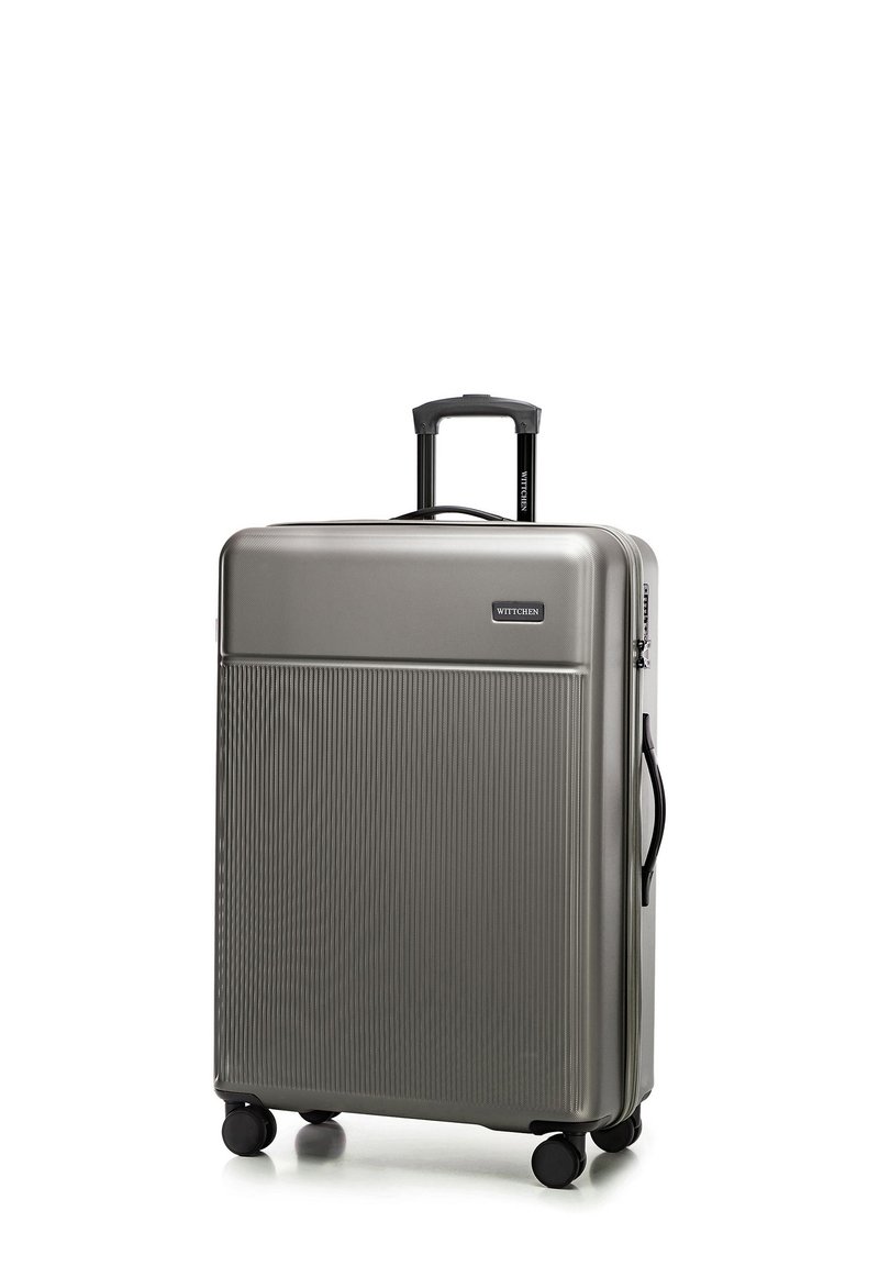 Silver hardshell suitcase with a textured surface, retractable black handle, four wheels, and a logo on the front panel.