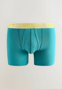 Türkiz boxer alsónadrág, sárga "NEXT" logóval a rugalmas derékrészen. Sima anyag, formázott fazon, kontúrozott zsebjével.