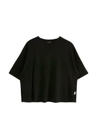 Svart oversized t-shirt i mjuk bomull, med korta ärmar, rund halsringning och sidofickor för en avslappnad passform.