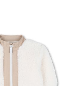 Witte fleece jas met een beige ritssluiting en kraag. Zachte textuur met een pluizige uitstraling, voorzien van een middellange snit en een minimalistische stijl.