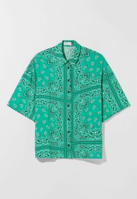 Short-sleeve shirt in bright teal, featuring intricate black paisley patterns and a button-down front; made of lightweight fabric.