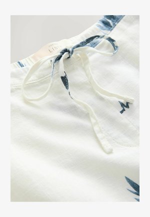 Biała lniana odzież z niebieskim akcentem w talii. Posiada zapięcie na sznurek oraz subtelny roślinny wzór. Miękka w dotyku i lekka.
