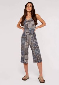 Blaues und beiges gemustertes Jumpsuit mit Spagettiträgern, kürzeren Beinen und lockerer Passform. Mit geometrischen und blumigen Designs.