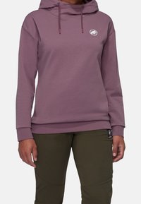 Hoodie i mauve med avslappnad passform, innehållande en känguruficka, dragsko och en cirkulär logotyp på bröstet.